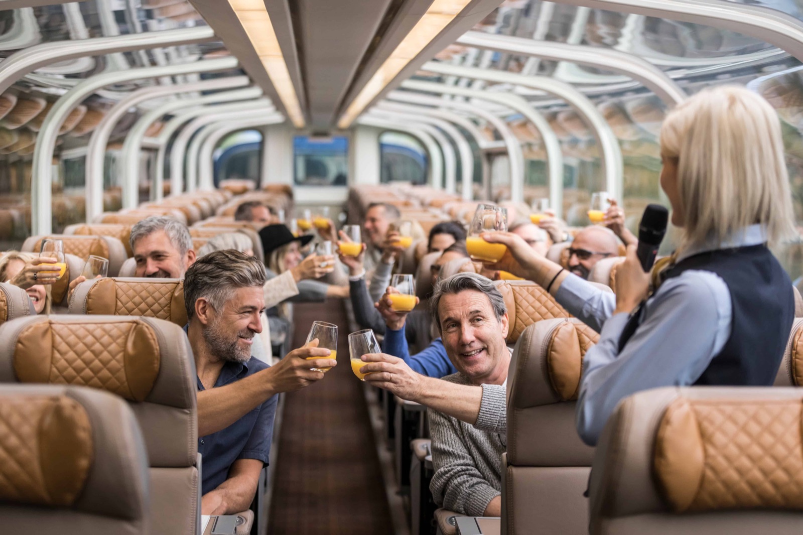 Rocky Mountaineer host serving guests on board in GoldLeaf Service