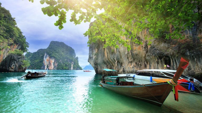 Boats Sailing Near Rocky Cliffs