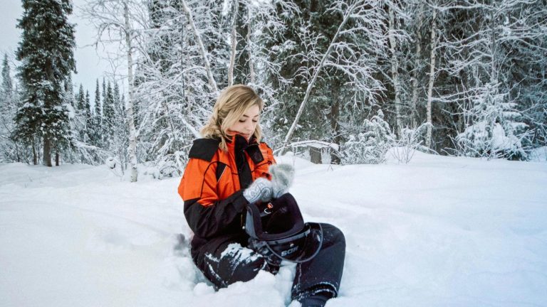 A woman sits in the snow