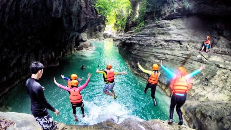 individuals in life jackets joyfully