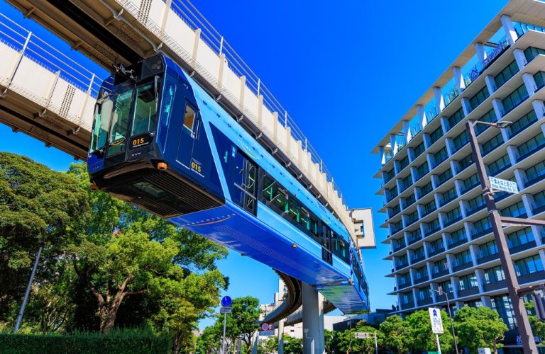 Blue train crossing a bridge