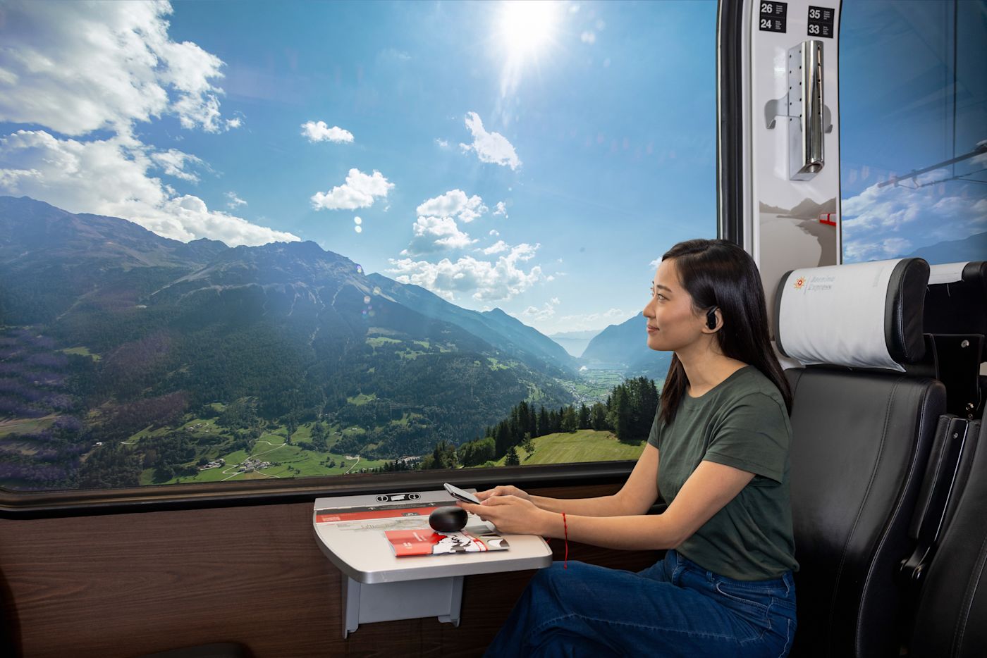 Traveller enjoying the valley view from a Bernina Express panoramic seat